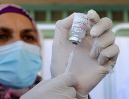 A Palestinian health worker holds a vial of the Moderna COVID-19 vaccine provided by Israel during vaccination in the West Bank city of Bethlehem on February 3, 2021.(Photo: Mosab Shawer/APA Images)