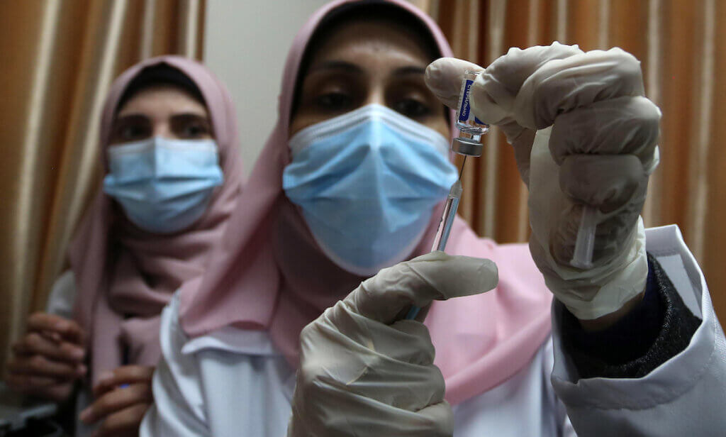 Palestinian doctors receive the first dose of a COVID-19 vaccine at the Ministry of Health, in Gaza City, on February 22, 2021. (Photo: Ashraf Amra/APA Images)