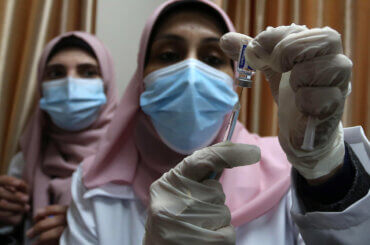Palestinian doctors receive the first dose of a COVID-19 vaccine at the Ministry of Health, in Gaza City, on February 22, 2021. (Photo: Ashraf Amra/APA Images)