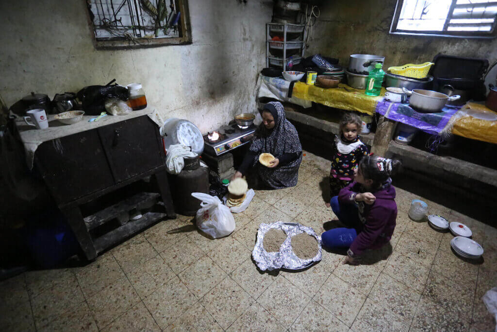 A Palestinian woman prepares breakfast during the holy month of Ramadan in Deir al-Balah refugee camp in central Gaza on April 20, 2021. (Photo: Ashraf Amra/APA Images)