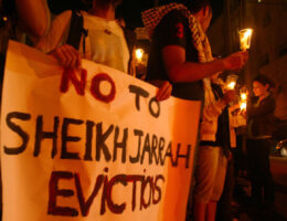 Demonstrators hold a sign as Israeli and foreign peace activists join Palestinians in a candlelight vigil in the East Jerusalem neighborhood of Sheikh Jarrah on August 10, 2009. (Photo: Mahfouz Abu Turk/APA mages)