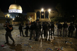 Israeli policemen gather during attacks on Palestinians at the compound that houses Al-Aqsa Mosque amid tension over the possible forced removal of several Palestinian families from homes on land claimed by Jewish settlers in the Sheikh Jarrah neighborhood, May 7, 2021. (Photo: Jamal Awad/APA Images)