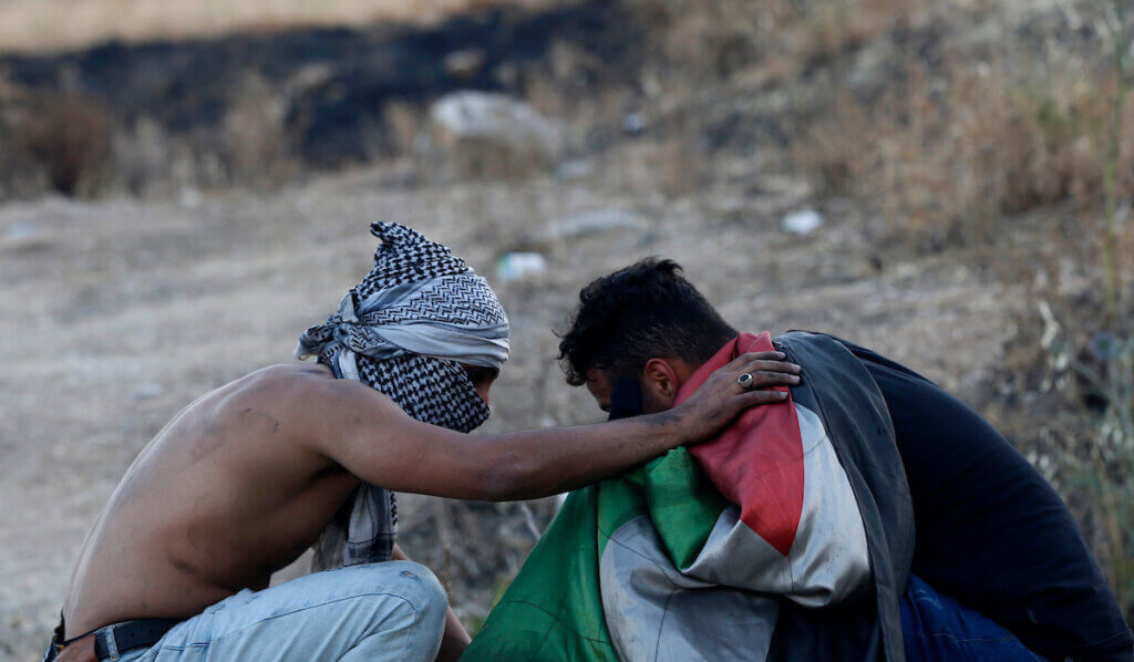Palestinian protesters clash with Israeli soldiers in solidarity with Gaza Strip and Jerusalem near the Hawara checkpoint south of the occupied West Bank city of Nablus on May 15, 2021. (Photo: Stringer/APA Images)