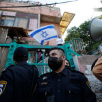 Israeli forces protect Israeli settlers outside a house in the Palestinian neighborhood of Sheikh Jarrah in occupied East Jerusalem on April 16, 2021. (Photo: Jamal Awad/APA Images)