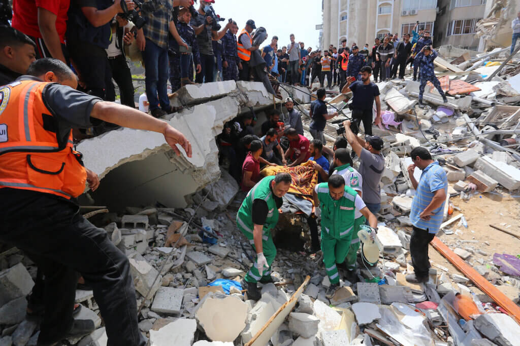 Palestinian rescue teams search for survivors under the rubble of a destroyed building in Gaza City's Rimal residential district on May 16, 2021. (Photo: Ashraf Amra/APA Images)