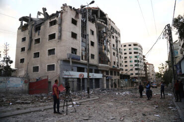 Palestinians inspect the rubbles of a building after hit by an Israeli airstrike in front of Health Ministry headquarter Gaza city on May 17, 2021. (Photo: Naaman Omar/APA Images)