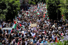 Palestinians protesting against Israel's occupation and its air campaign on the Gaza strip, shout slogans as they face Israeli troops near the settlement of Beit El and Ramallah in the occupied West Bank on May 18, 2021. (Photo: Ibrahim Attaia/APA Images)