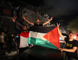 Palestinians celebrate in the streets following a ceasefire brokered by Egypt between Israel and Hamas, in Gaza City on May 21, 2021. (Photo: Ashraf Amra/APA Images)