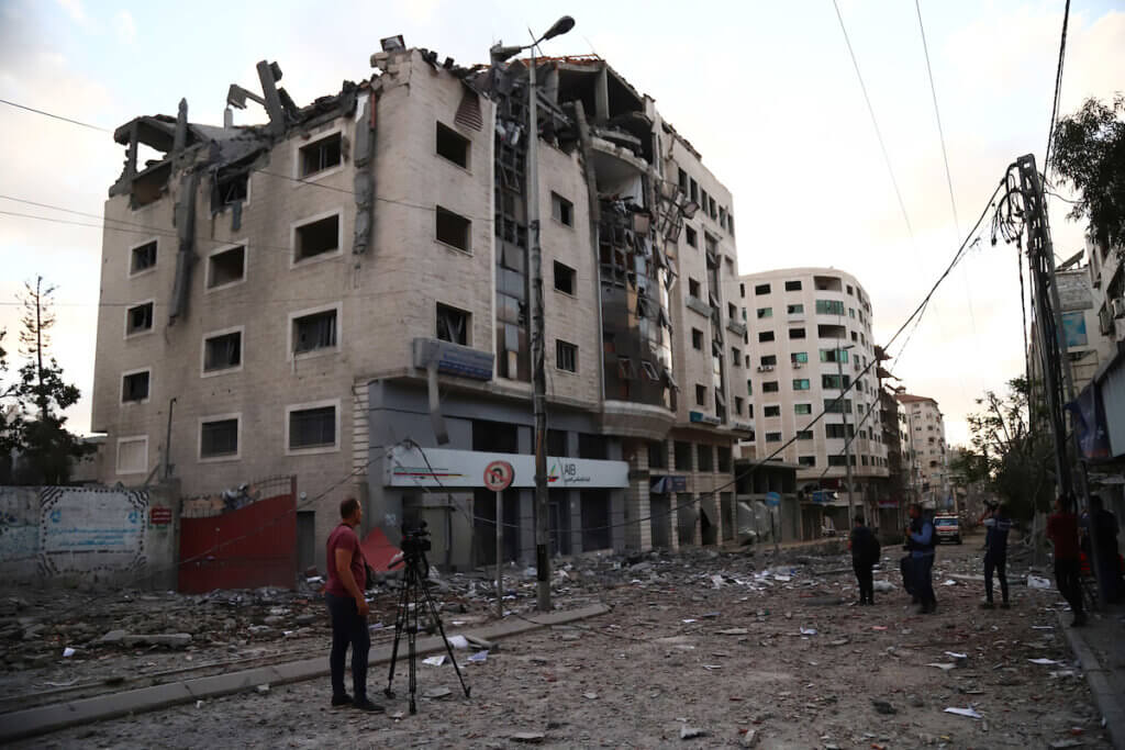 Palestinians inspect the damage to the Ministry of Health headquarters in Gaza City after it was hit by an Israeli airstrike, May 17, 2021. (Photo: Naaman Omar/APA Images)