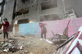 Palestinians paint and plant trees on the land of Abu Hatab family house that was destroyed in an Israeli air trike earlier in the Shati beach refugee camp in Gaza on 17 June 2021. (Photo: Omar Ashtawy/APA Images)