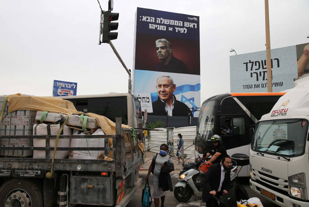Israeli Prime Minister Benjamin Netanyahu pictured below Yesh Atid leader Yair Lapid who will be sworn in as prime minister Yemina’s Naftali Bennett. Lapid and Bennett are prepared to replace the incumbent Netanyahu after forming a rotational governing coalition on June 2, 2021. (Photo: Jamal Awad/APA Images)