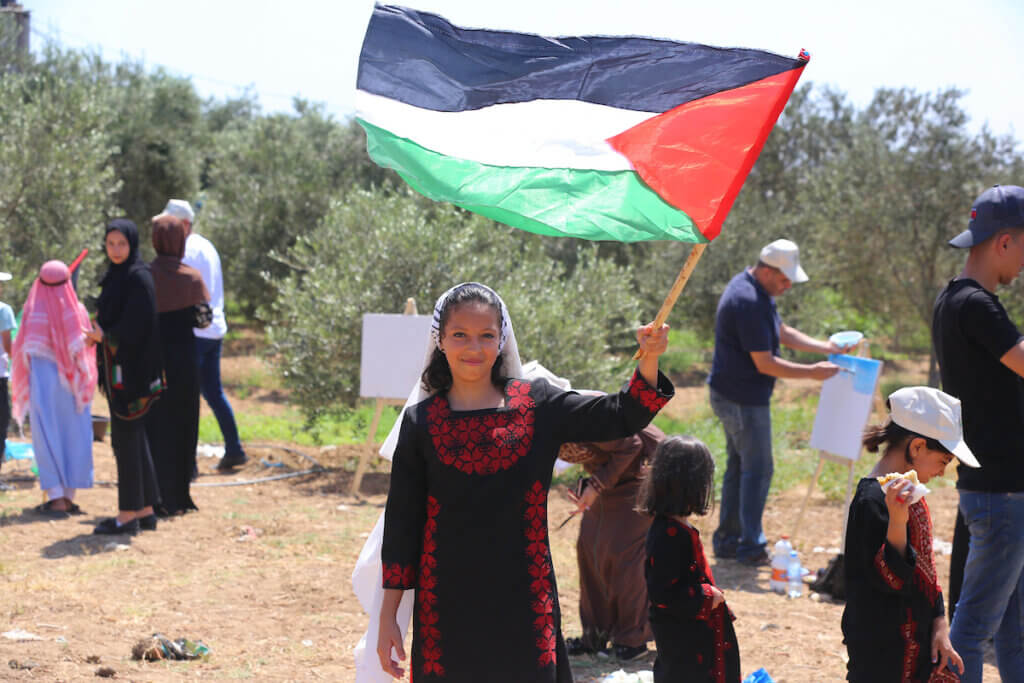 Palestinians take part in an event calling for the implementation of the Palestinian right of return near the border fence with Israel, in Maghazi refugee camp in the central Gaza Strip on July 1, 2021. (Photo: Ashraf Amra/APA Images)
