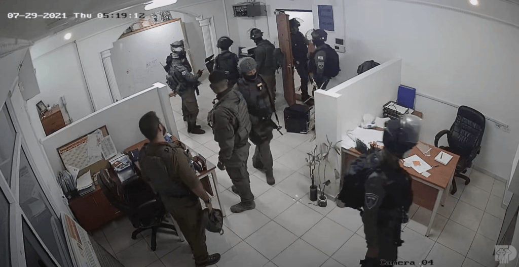 Screenshot from security cam footage showing Israeli forces raiding Defense for Children International - Palestine’s headquarters