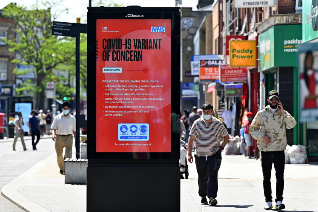 Pedestrians walk past a sign warning members of the public about the spread of coronavirus delta variant in Hounslow, West London, on June 1, 2021. (Photo: Justin Tallis/AFP/Getty Images)