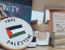 Some of the contents of Menna Hijazi's emergency bag she packed to escape her house during an Israeli attack in May 2021. It included a piece of embrodery from a roommate during a study abroad in the United States.