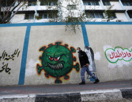 Palestinians walk by a UN school closed due to lockdown orders in Gaza City on April 6, 2021. (Photo: Ashraf Amra)