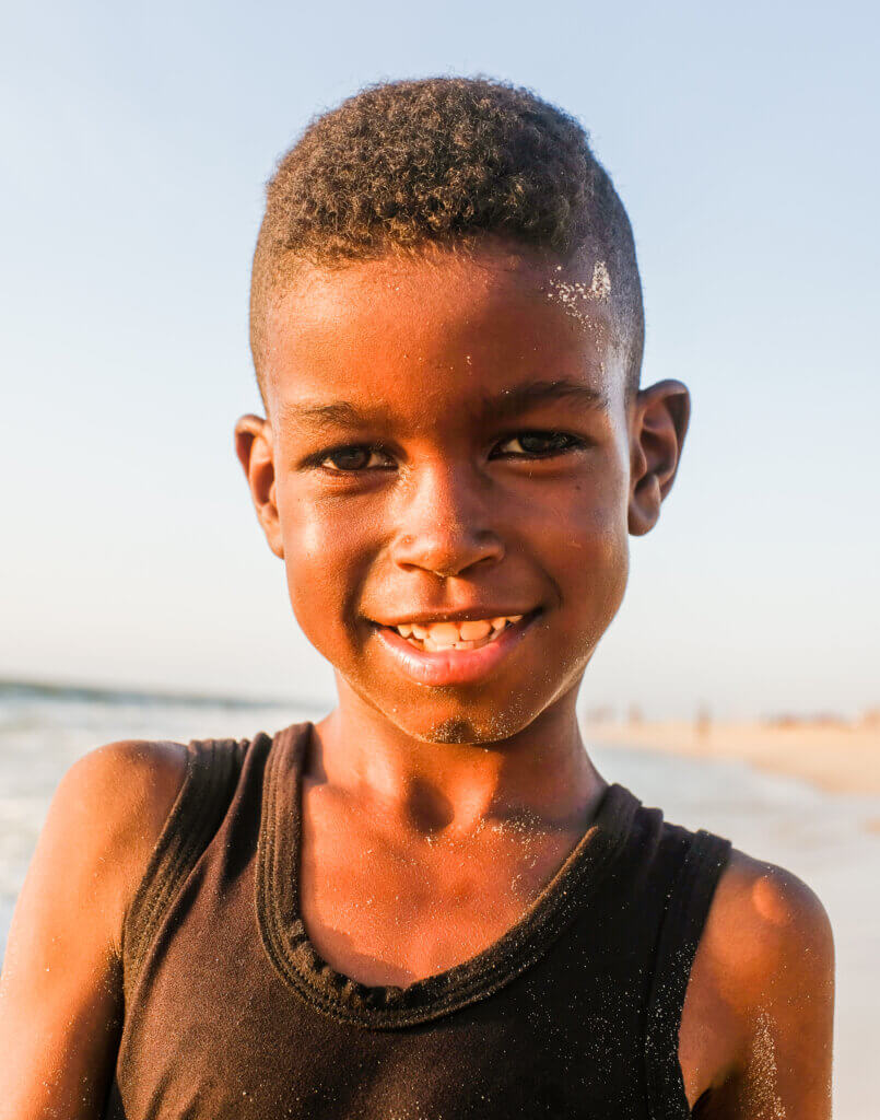 A Palestinian child poses for a portrait on the shore of a beach outside the center of Gaza on August 12, 2021. (Photo: Mahmoud Nasser)