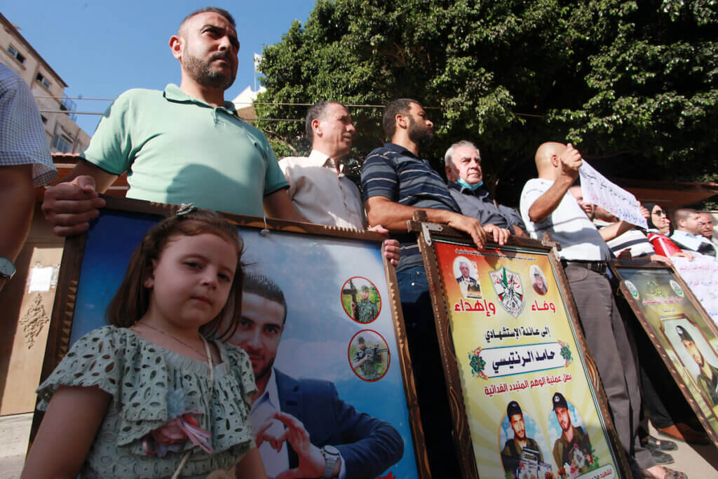 Palestinians take part in a rally in front of Red Cross offices in Gaza city demanding that Israel return the detained bodies of Palestinians killed by the Israeli military, on August 29, 2021. (Photo: Omar Ashtawy/APA Images)