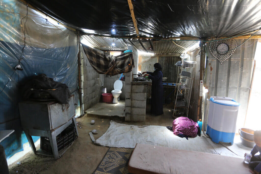 Zohra Abu Shaer inside the dwelling she shares with her husband and 13 children in Deir al-Balah refugee camp in the central Gaza Strip on April 21, 2021. (Photo: Ashraf Amra/APA Images)