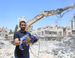 Palestinian engineer Ahmed Al-Qiq, 30, inspects damage at his center for the training and development, which was destroyed by Israeli air strikes during the May 2021 conflict between Hamas and Israel in Gaza City on June 29, 2021. (Photo: Ashraf Amra/APA Images)