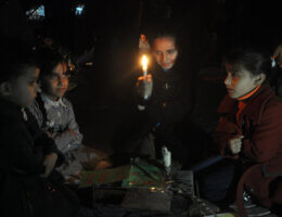 Palestinian school children warm gather around a candle during severe fuel cuts that led to power shortages in Gaza City on November 12, 2013. Gaza is dependent on electricity purchased directly from Israel and Egypt, with outage and blackout reaching up to 12 hours a day. (Photo: Mohammed Talatene/APA Images)