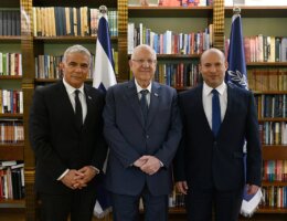 Yair Lapid (left), Reuven Rivlin (center), and Naftali Bennet (right) following the agreement to form the 36th government of Israel, June 14, 2021. (Photo credit: Haim Tzach / GPO)