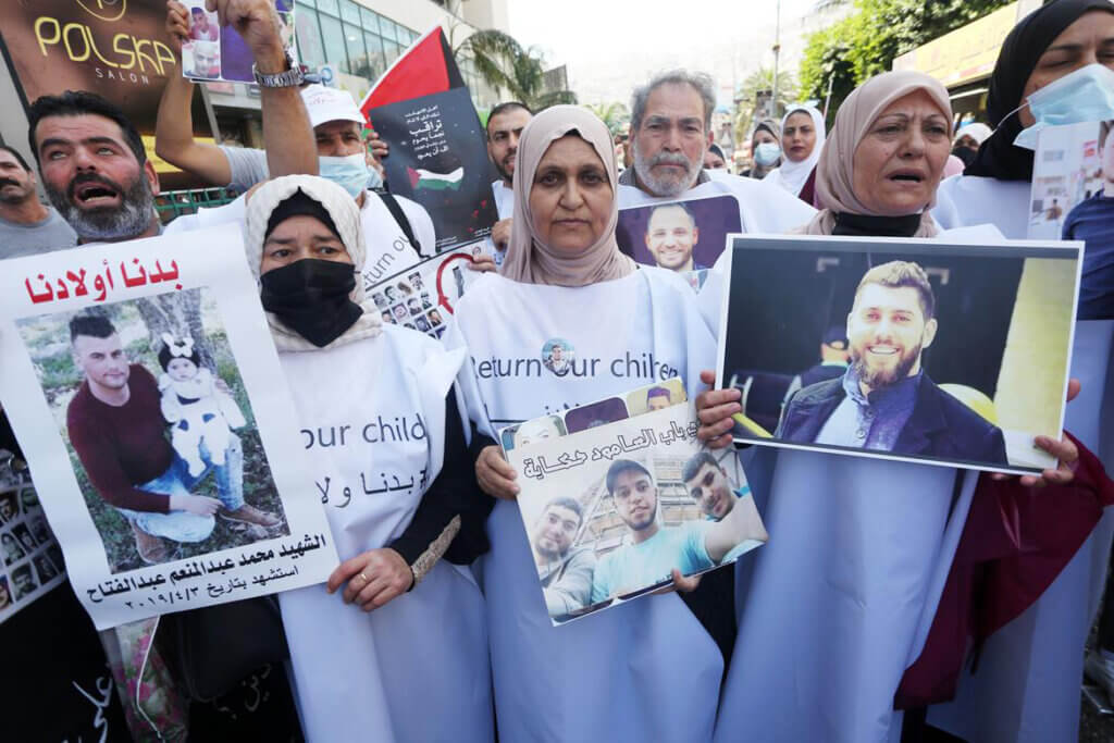 Palestinians take part in a rally demanding Israel return the bodies of Palestinians killed by the Israeli army and then detained as part of the National Day for the Repatriation of the Bodies of Palestinians Killed by the Israeli Army, in the West Bank city of Nablus on August 29, 2021. (Photo: WAFA via APA Images)