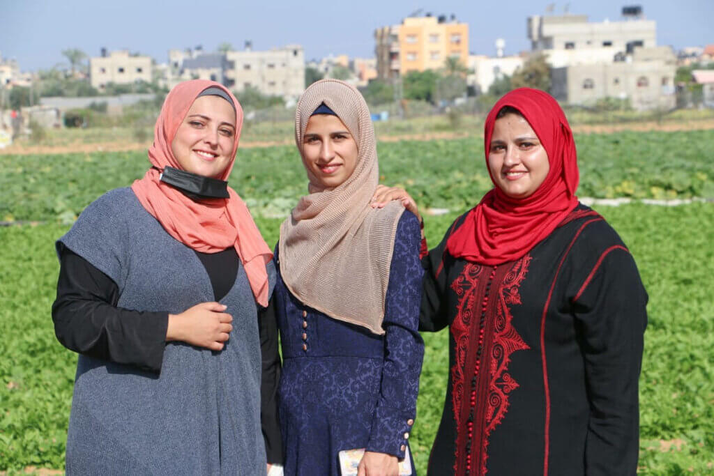 Aseel Al-Najjar, Nadine Abu Rouk, and Ghaida Qudeih on their agricultural land outside of Khuza'a.