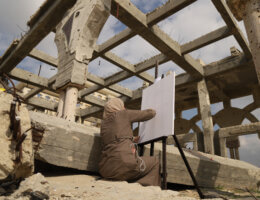 An artist prepares her canvas in the ruins of the Yasser Arafat International Airport in Gaza. (Photo: Aseel Kabariti)