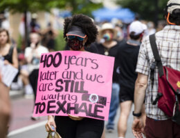 A protester walks with a sign near the White House during George Floyd protests on June 6, 2020 in Washington, D.C. (Photo: Samuel Corum/Getty Images)