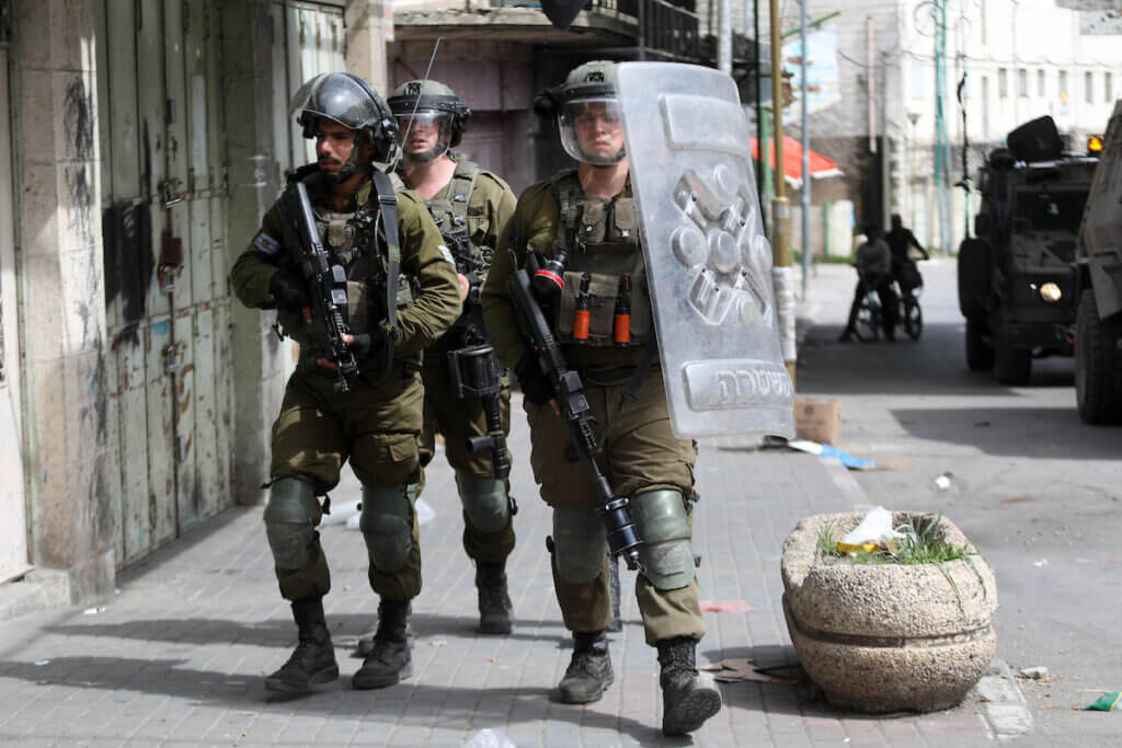 Israeli forces crack down on Palestinian protesters following a demonstration against settlements, in the West Bank city of Hebron on April 1, 2022. (Photo: Mamoun Wazwaz/APA Images)