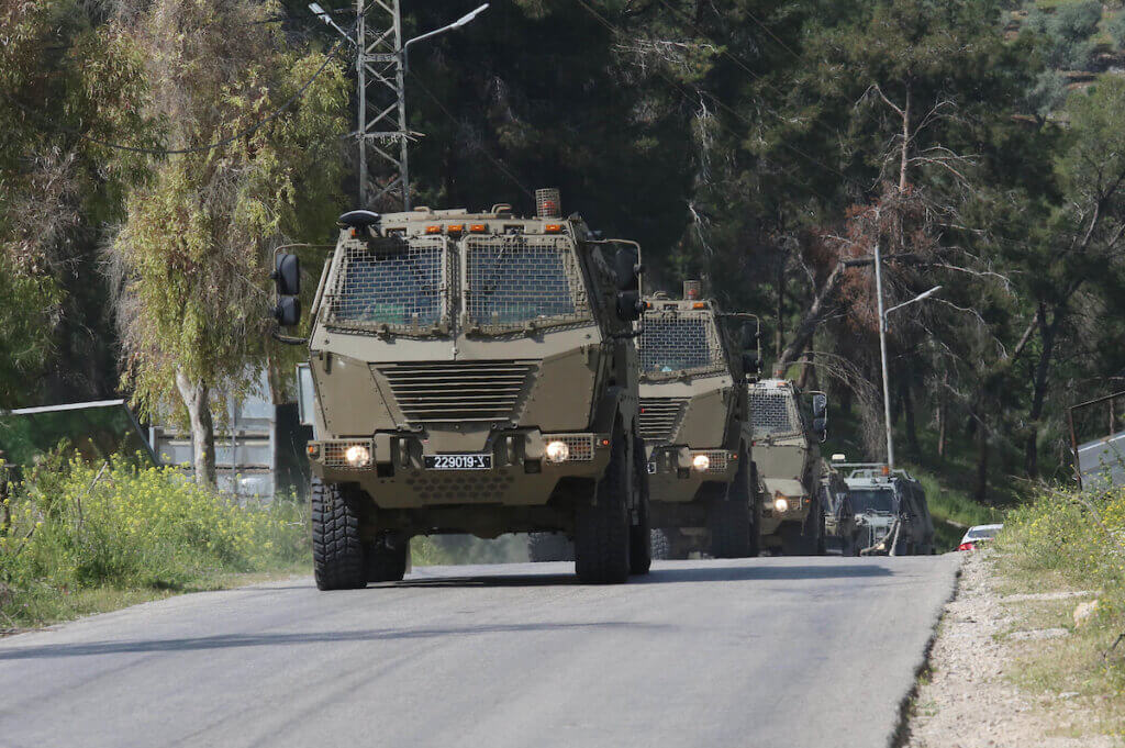 Israeli military vehicles heading toward the Jenin refugee camp in the West Bank on April 9, 2022. (Photo: Wajed Nobani/APA Images)