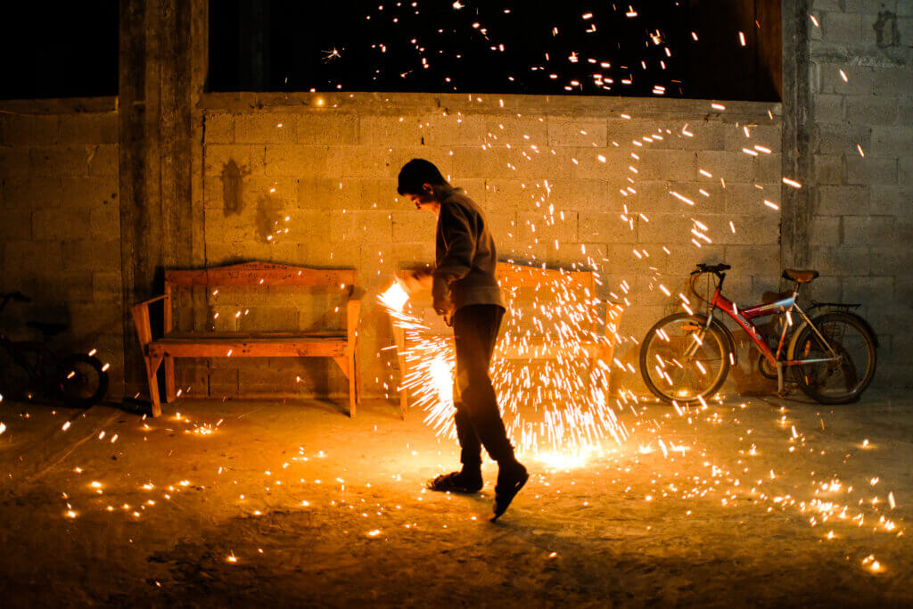 A teen is seen swinging in Arabic ‘silk Jalee’, a kitchen cleaning tool that when lit on fire and swung, sends sparks in all directions. A sight only seen during the month of Ramadan. Beit Hanoun, Gaza, April 2, 2022