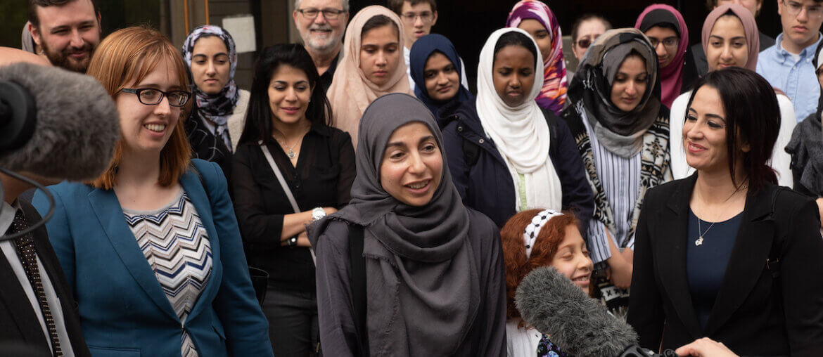 Bahia Amawi speaking to journalists at a press conference outside of a Texas courthouse as seen in Just Vision’s documentary Boycott. (Photo: Jonah Candelario)