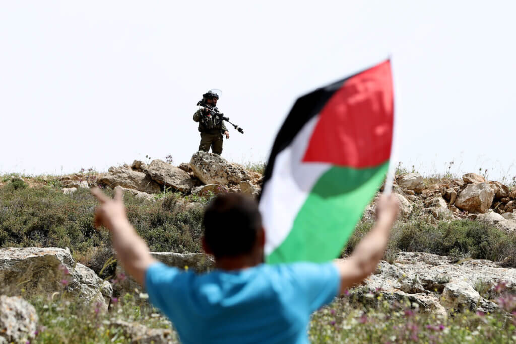 Palestinian protesters clash with Israeli forces following a protest against the expansion of Jewish settlements in the West Bank village of Beit Dajan on April 22, 2022. (Photo: Stringer/APA Images)
