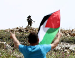 Palestinian protesters clash with Israeli forces following a protest against the expansion of Jewish settlements in the West Bank village of Beit Dajan on April 22, 2022. (Photo: Stringer/APA Images)