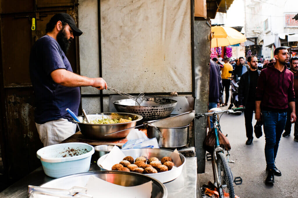 A street vendor makes a unique version of falafel specific to Ramadan called ‘Tamiya’ in Souq Al-Zawya, Gaza, on April 4, 2022