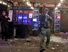 A policeman gestures at the scene in the aftermath of a shooting attack in Dizengoff Street in Tel Aviv, April 7, 2022. (AFP via Getty Images)
