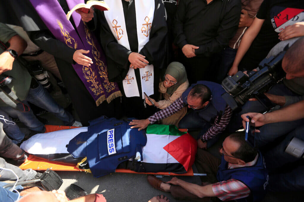Mourners carry the body of Al Jazeera reporter Shireen Abu Akleh, who was killed by Israeli army gunfire during an Israeli raid, during her funeral in West Bank city of Jenin on May 11, 2022. (Photo: Shadi Jarar'ah/APA Images)
