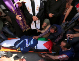 Mourners carry the body of Al Jazeera reporter Shireen Abu Akleh, who was killed by Israeli army gunfire during an Israeli raid, during her funeral in West Bank city of Jenin on May 11, 2022. (Photo: Shadi Jarar'ah/APA Images)