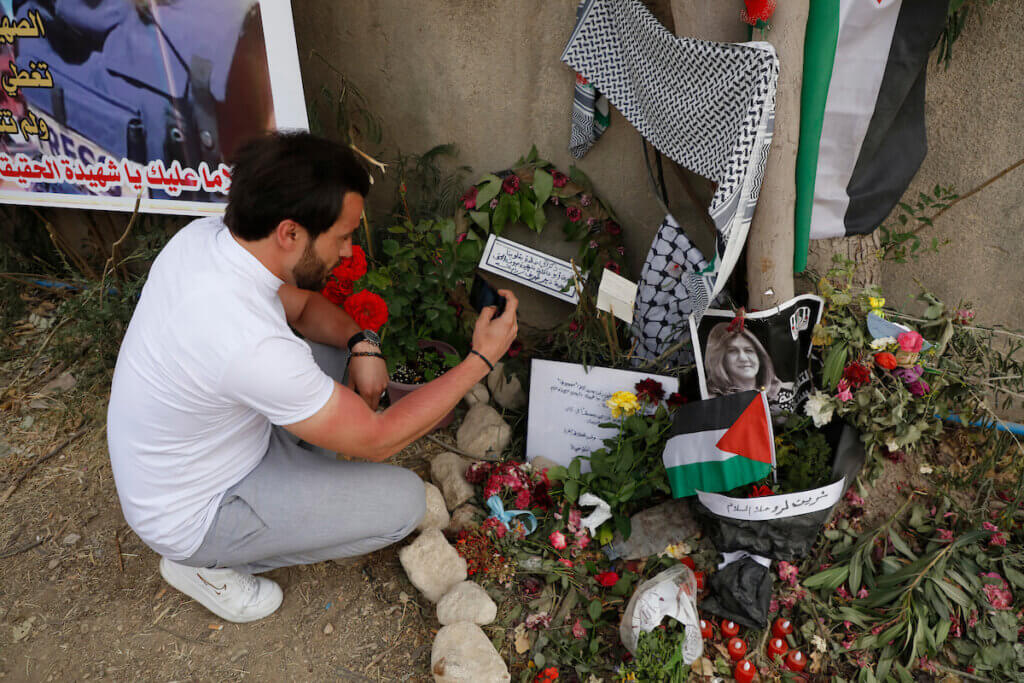 Palestinians establish a makeshift shrine near the site Al Jazeera journalist Shireen Abu Akleh was killed in Jenin while covering an Israeli army raid in the occupied West Bank, on May 14, 2022. (Photo: Ahmed Ibrahim/APA Images)