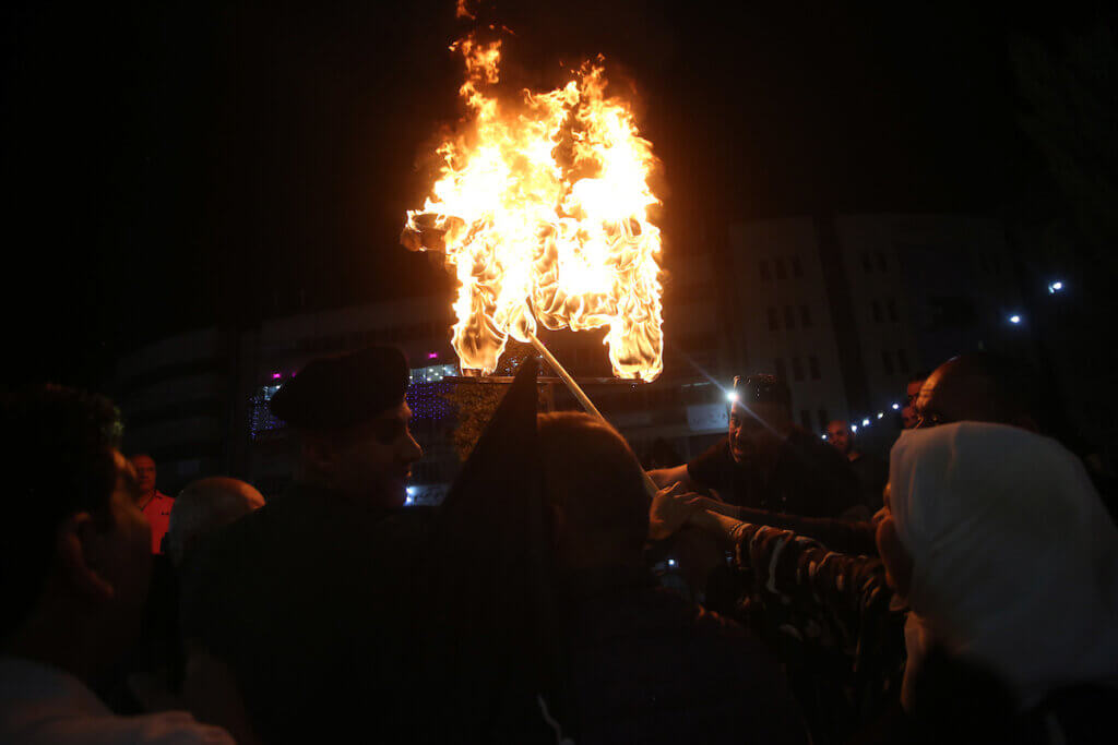 Palestinians light a torch during a celebration marking of the 74th anniversary of the Nakba, the "catastrophe" of Israel's creation in 1948, in the West bank city of Nablus on May 14, 2022. (Photo: Shadi Jarar'ah/APA Images)