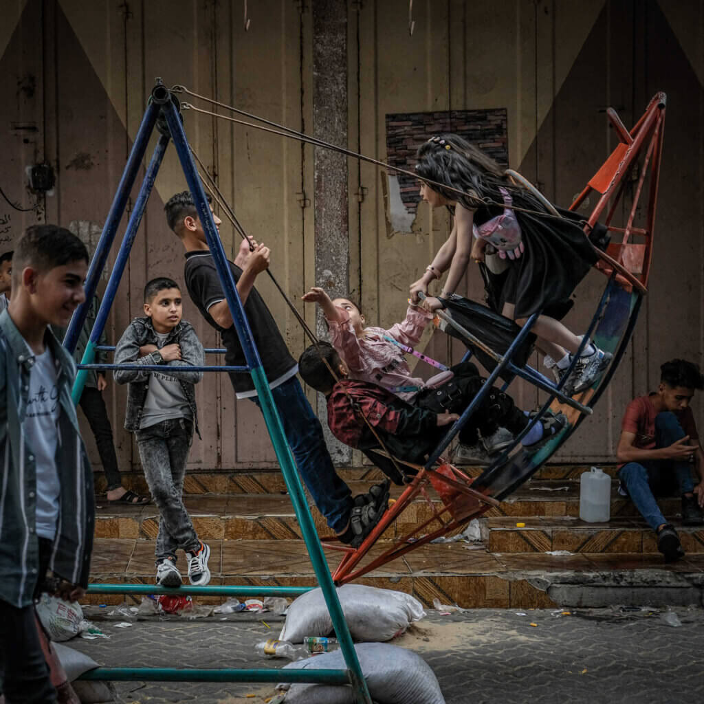 A group of kids swinging on a makeshift amusement ride on the second day of Eid Al-Fitr in Gaza City. (Photo: Mohammed Salem)