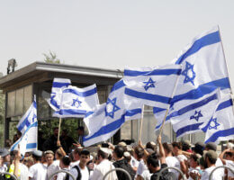 Israeli settlers wave Israeli flags near Damascus gate during the 'flags march' in Jerusalem on May 29, 2022. (Photo: Jeries Bssier/APA Images)
