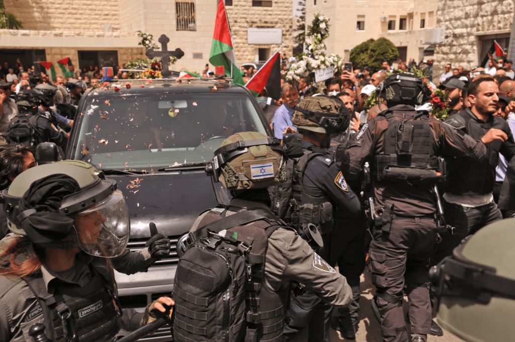 Israeli security forces surround the vehicle carrying the casket of Shireen Abu Akleh out of the St Louis French Hospital in occupied East Jerusalem’s Sheikh Jarrah neighborhood. before being transported to a church and then her resting place in Jerusalem. (Photo: Ahmad Gharabli/AFP)