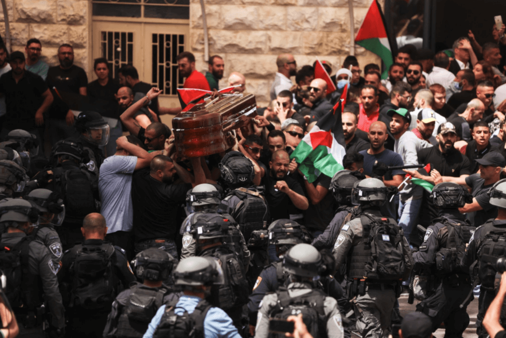 Israeli security forces attack pallbearers carrying the casket of Shireen Abu Akleh out of the St Louis French Hospital in occupied East Jerusalem’s Sheikh Jarrah neighborhood. before being transported to a church and then her resting place in Jerusalem. (Photo: Ahmad Gharabli/AFP)