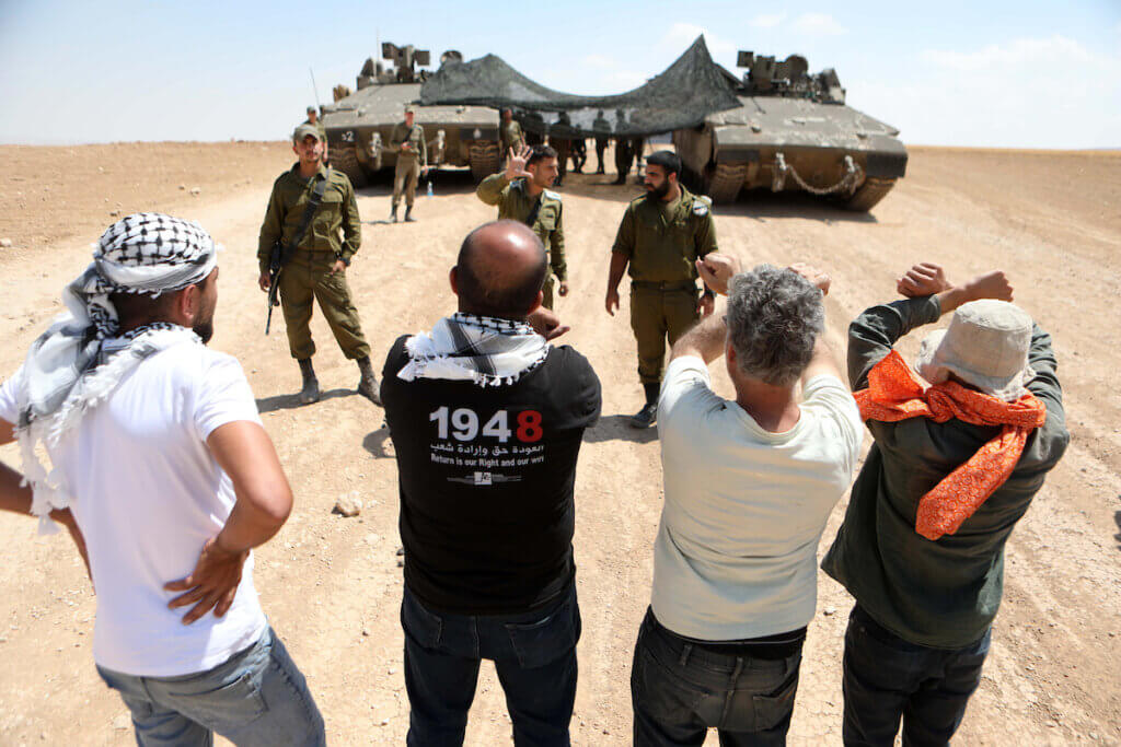 Israeli soldiers confront Palestinian activists during a protest against the Israeli military drill, in Masafer Yatta, south of Hebron, in the West Bank on June 22, 2022. (Photo: Mamoun Wazwaz/APA Images)
