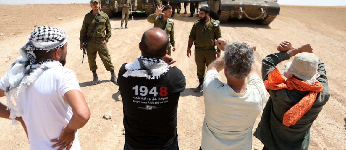 Israeli soldiers confront Palestinian activists during a protest against the Israeli military drill, in Masafer Yatta, south of Hebron, in the West Bank on June 22, 2022. (Photo: Mamoun Wazwaz/APA Images)