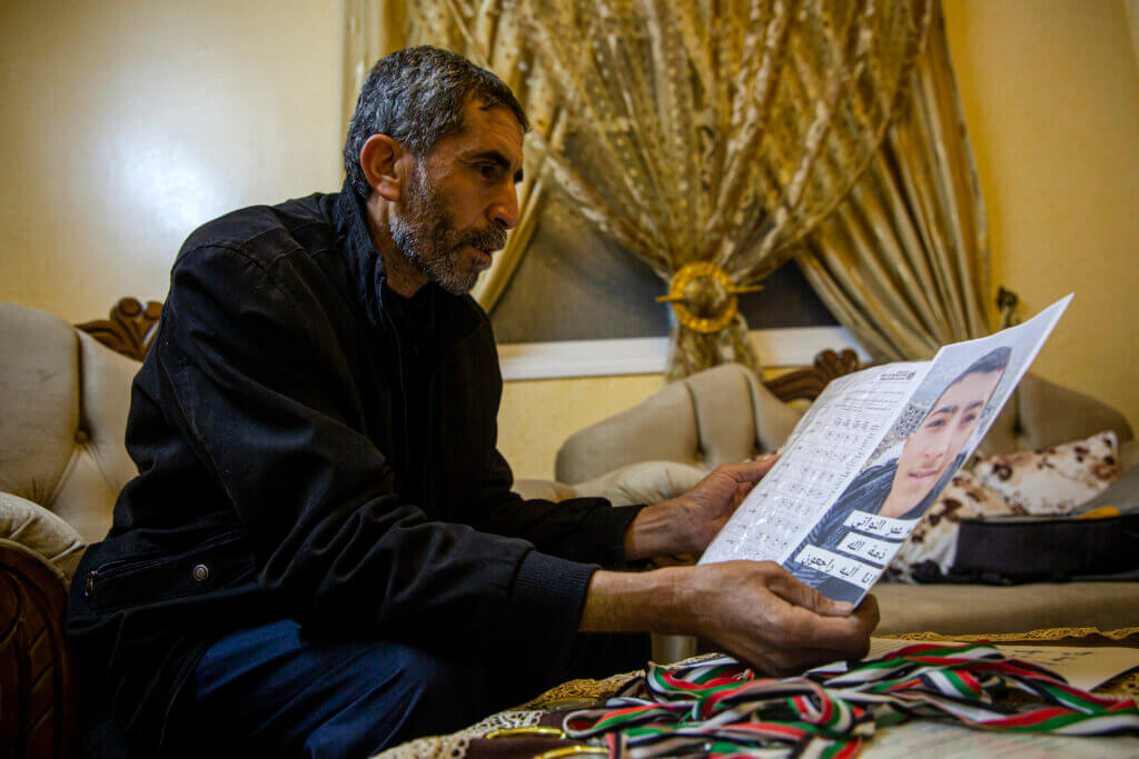 Omar Nawaty looks at a photo of his son, Saleem Nawaty, surrounded by paraphernalia of his son's life (Photo: Mohammed Salem)