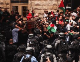 Israeli security forces attack pallbearers carrying the casket of Shireen Abu Akleh out of the St. Louis French Hospital in Occupied East Jerusalem's Sheikh Jarrah neighborhood before being transported to a church and then her resting place in Jerusalem. (Photo: Ahmad Gharabli/AFP)